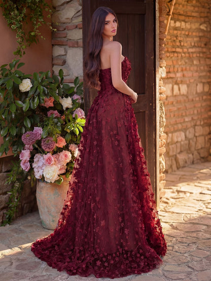 Burgundy strapless floral wedding guest dress with thigh-high slit