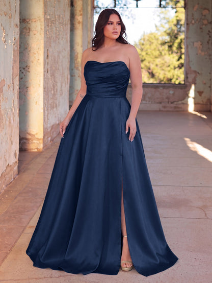 Full-length front view of a navy blue strapless satin A-line gown with high slit